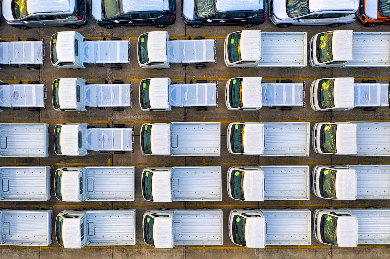 Overhead view of a fleet of trucks neatly parked in a seaport area of Jakarta, Indonesia.